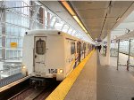 A train of the older Mark Series Cars arrives at Main Street-Science World Station heading to the Waterfront Station